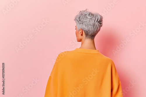 Peaceful Solitude: Woman with Short Gray Hair in a Modern Minimalistic Interior, Captured from Behind with Soft Lighting