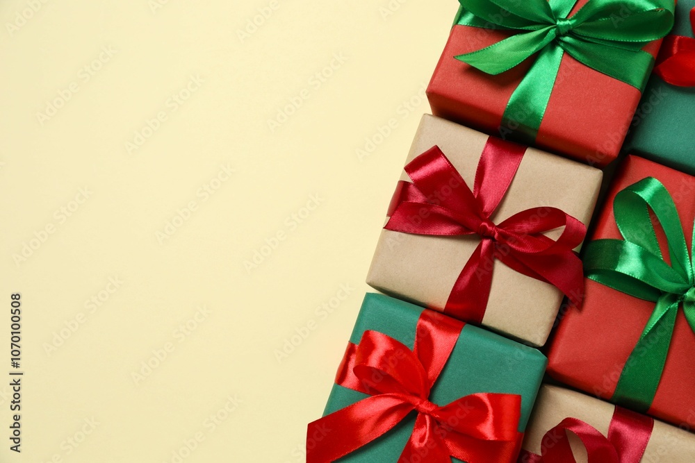 Beautiful gift boxes tied with bows on color background Beautiful gift boxes tied with bows on color background