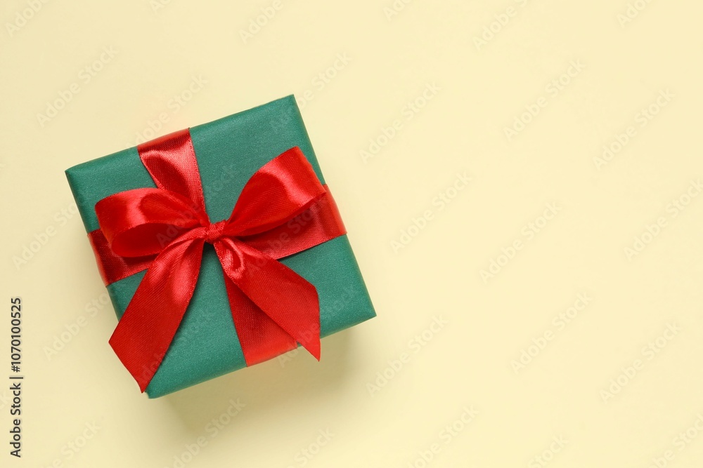 Beautiful gift box tied with bow on color background Beautiful gift box tied with bow on color background