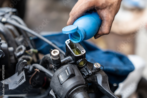 Obraz na płótnie Mechanic check and Add Brake Fluid on motorcycle brake reservoir in garage, motorcycle repair concept w salonie