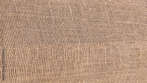 Full frame texture of a jute rug. Jute pattern, rough burlap texture, canvas coarse cloth, brown woven rustic bagging. 