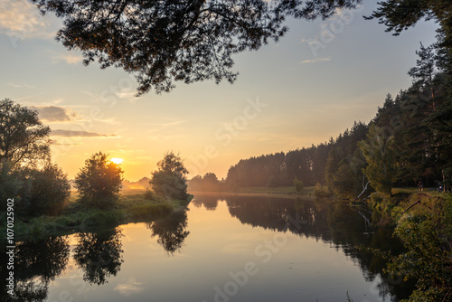 Calm river with a beautiful sunset in the background