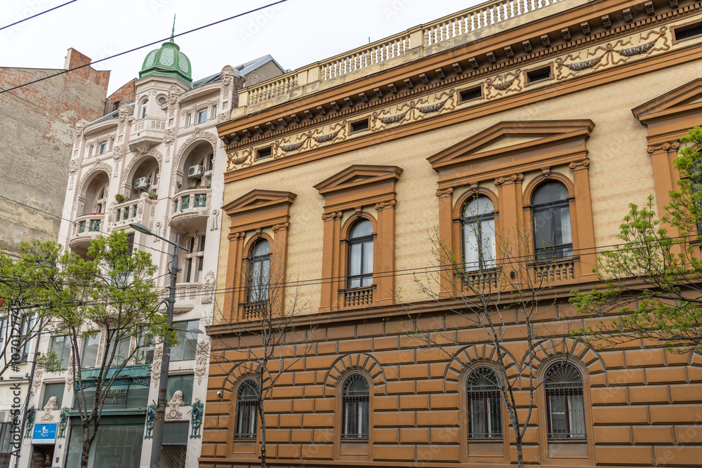 Obraz premium Brown building with a green dome sits next to a white building