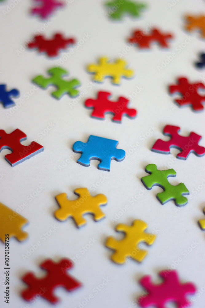 Obraz premium Colorful jigsaw puzzle pieces on white background. Selective focus.