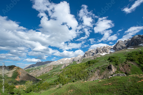 Green plains, snowy mountains. Blue sky and snowy mountains. Snowy mountains of Tunceli. Pülümür Valley, Buyer Mountain, Sarıgül Plateau, Buyer Waterfall.Munzur, Tunceli, Türkiye. 