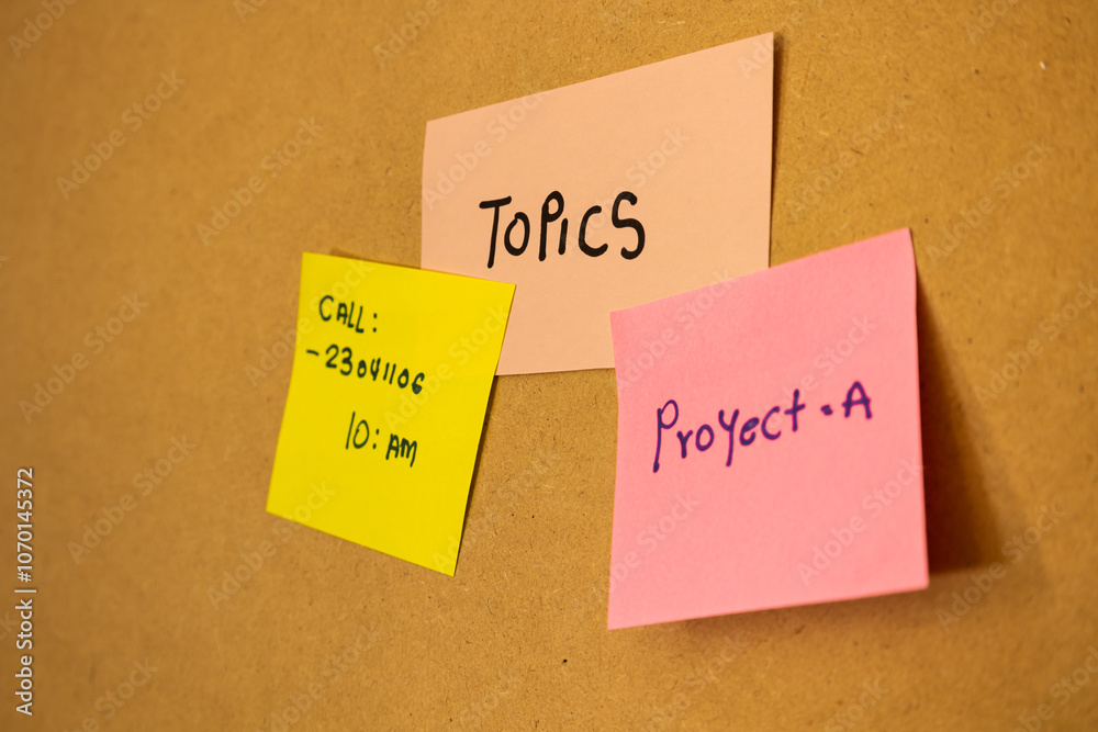 Close up of colorful notes stuck on a blackboard, concept of notes and topics Close up of colorful notes stuck on a blackboard, concept of notes and topics