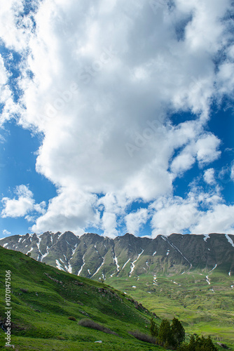 Green plains, snowy mountains. Blue sky and snowy mountains. Snowy mountains of Tunceli. Pülümür Valley, Buyer Mountain, Sarıgül Plateau, Buyer Waterfall.Munzur, Tunceli, Türkiye.
 photo