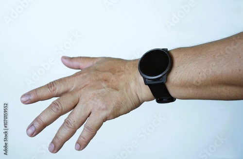 Outstretched hand wearing a black smartwatch Demonstrate care for your body and care for your health. photo