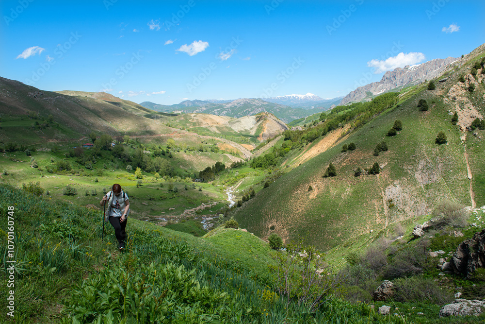 People walking on green land. Trekking and hiking in Tunceli mountains. Green mountains and plains of Tunceli. Pülümür Valley, Buyer Mountain, Sarıgül Plateau. Tunceli, Türkiye. People walking on green land. Trekking and hiking in Tunceli mountains. Green mountains and plains of Tunceli. Pülümür Valley, Buyer Mountain, Sarıgül Plateau. Tunceli, Türkiye.