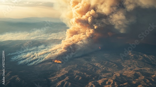 Pyrocumulus clouds forming above a large wildfire, towering high with dense smoke and ash photo