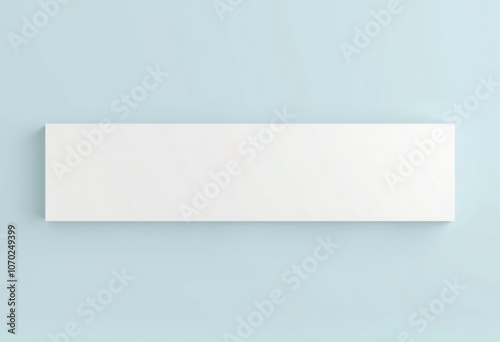 A blank white canvas mockup on a light blue wall.