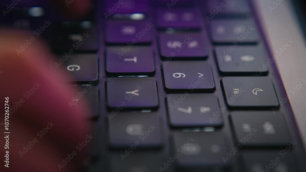 Macro shot of fingers typing on a laptop keyboard, capturing the detailed movement of the keys and fingertips in action. Macro shot of fingers typing on a laptop keyboard, capturing the detailed movement of the keys and fingertips in action.