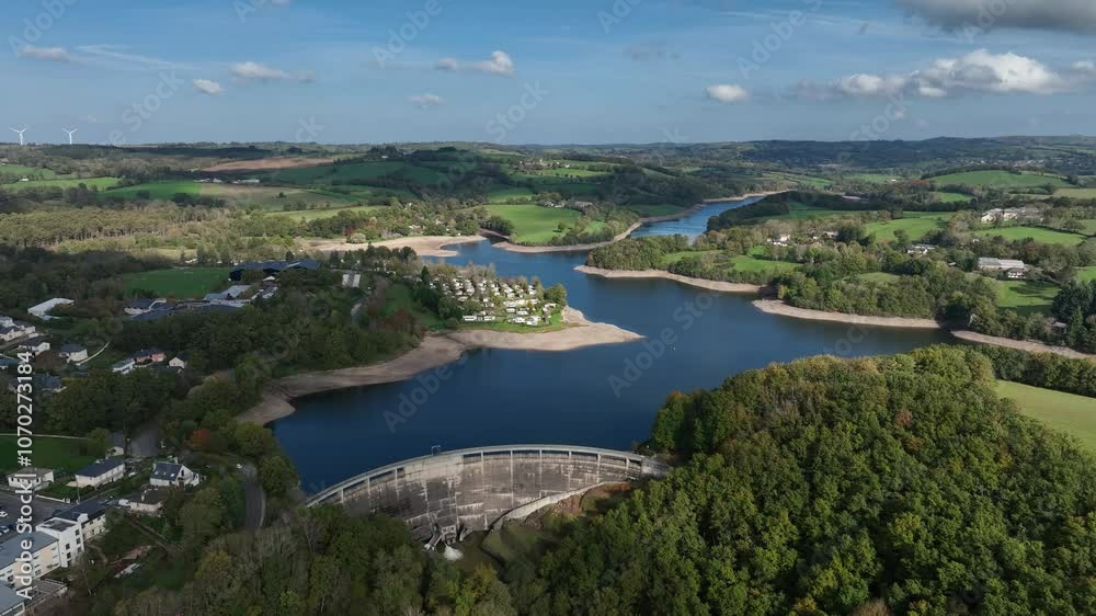 The Pinet Dam nestled in a green valley, highlighting its robust structure and tranquil water The Pinet Dam nestled in a green valley, highlighting its robust structure and tranquil water