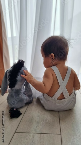 child playing with Eeyore photo