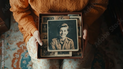 Elderly hands holding a box filled with nostalgic vintage photographs, highlighting precious memories and historical family heritage. photo