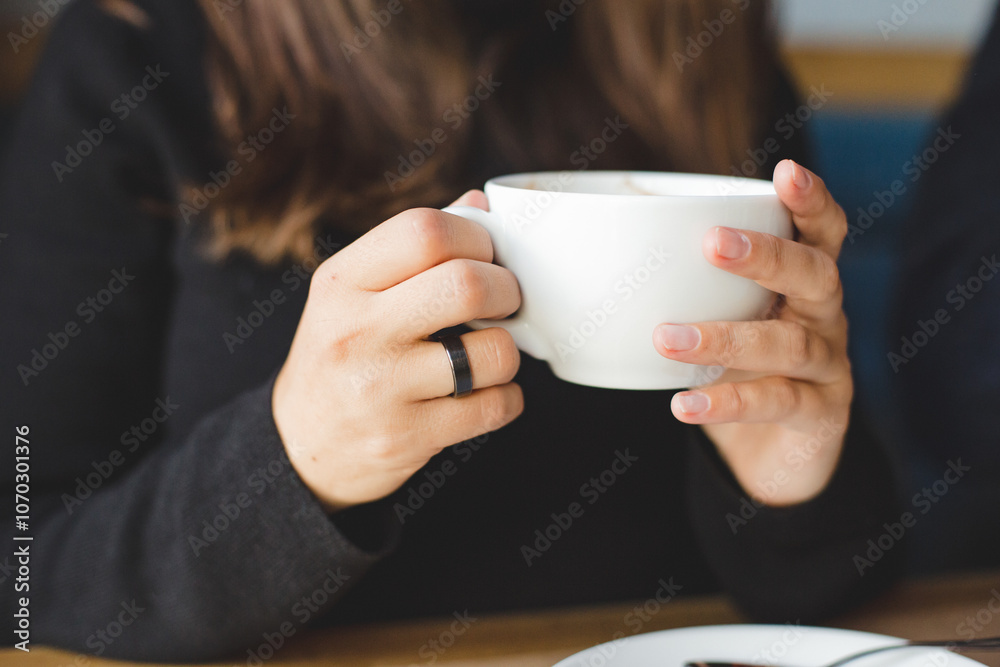 woman drinking coffee in a cafe