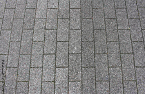 Gray square paving tile. Brick pavement texture. Concrete pavers background.	