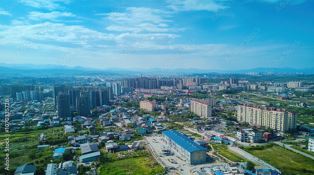 Panoramic aerial view of cityscape under clear blue sky. Panoramic aerial view of cityscape under clear blue sky.