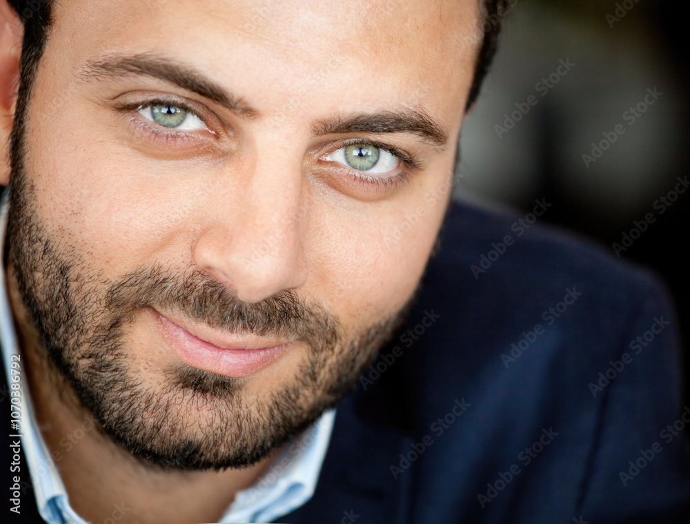 Portrait of a confident businessman smiling slightly and showing his beautiful green eyes Portrait of a confident businessman smiling slightly and showing his beautiful green eyes