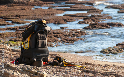 Freediving equipment left on the beach by spearfisher after a fishing session photo