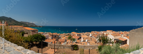 Narrow street in the old town of Cefalu in Sicily, Italy in a beautiful summer day. Travel and sightseeing journey concept. photo