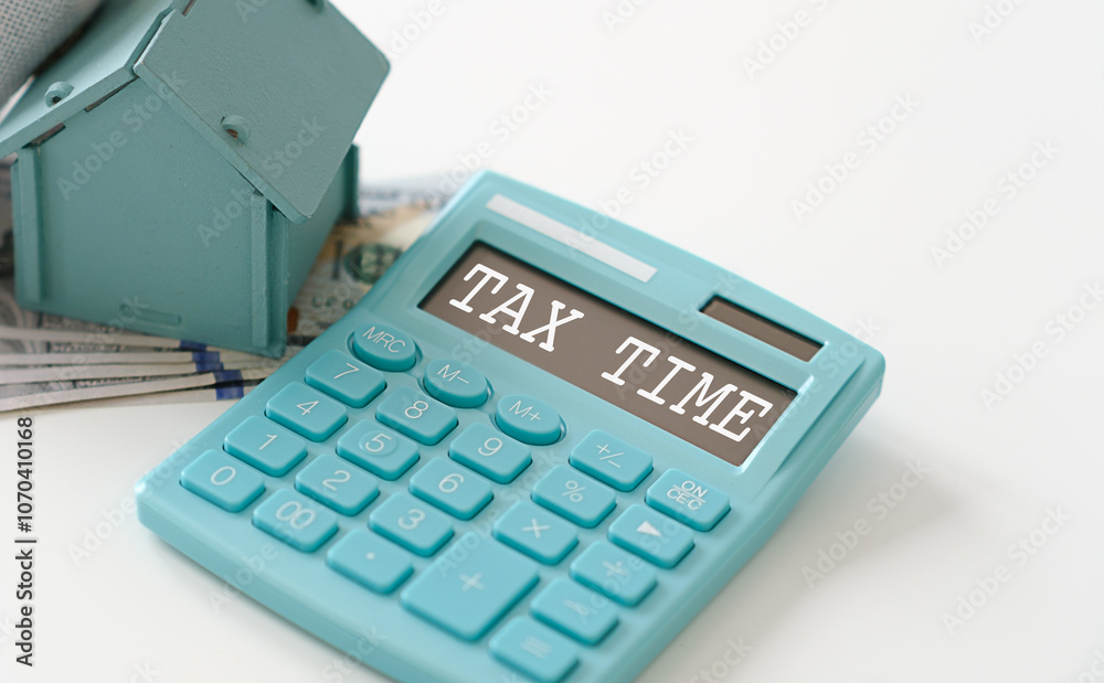 A blue calculator with the word tax time written on it A blue calculator with the word tax time written on it