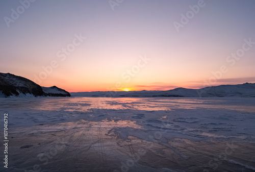 фотографія Snowy cracky ice of lake Baikal and the rocky island