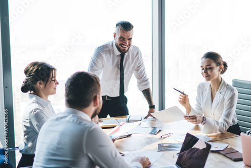 Manager making report to colleagues and talking with smile