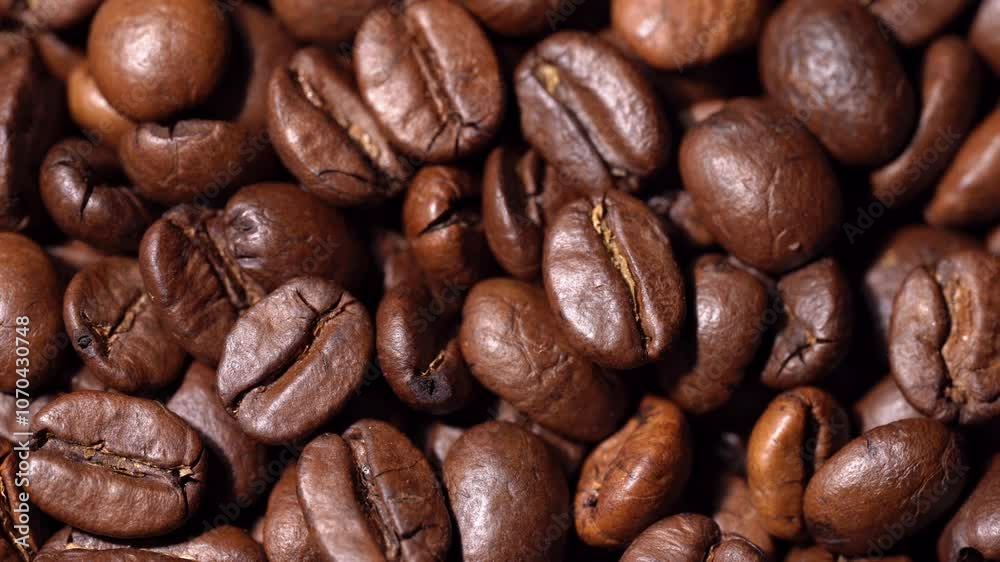 Close-up of coffee beans rotating. Coffee. Invigorating drink. Texture of coffee beans