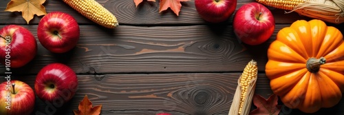 A vibrant autumn display featuring apples, corn, and a pumpkin on a rustic wooden background, perfect for seasonal marketing and harvest-themed projects. photo