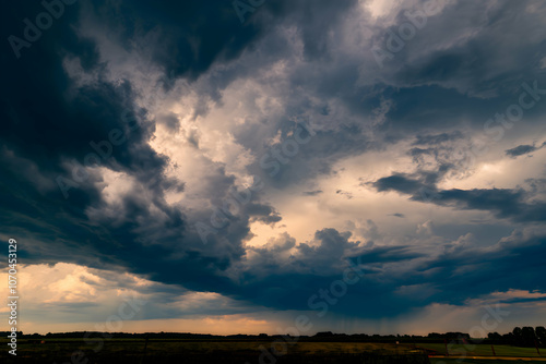 Dark, ominous clouds with light breaking through, hinting at storm