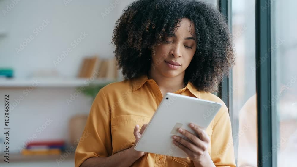 Video of entrepreneur woman using her digital tablet while standing in a modern startup Video of entrepreneur woman using her digital tablet while standing in a modern startup