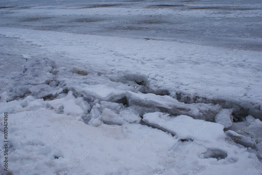 Ice covered with snow. Winter. View of frozen river. Nature. Ice covered with snow. Winter. View of frozen river. Nature.