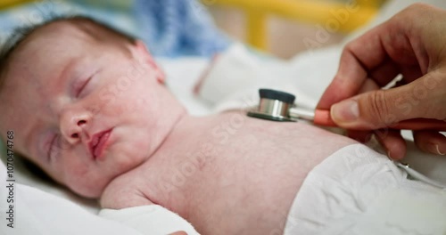A healthcare professional assesses a newborn using a stethoscope in a hospital setting. Conducting a comprehensive health check for newborns in the neonatal unit is essential