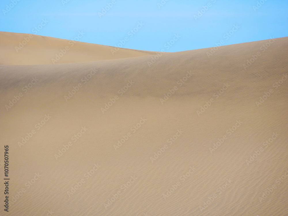 Sand textured pattern with copy space close up in Maspalomas, Gran Canaria. Abstract background wallpaper. Sand waves in a desert dune against the sky Sand textured pattern with copy space close up in Maspalomas, Gran Canaria. Abstract background wallpaper. Sand waves in a desert dune against the sky