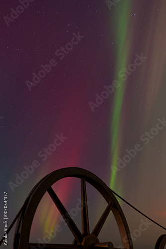 Streams of Northern Lights with Spinning Wheel in Foreground photo