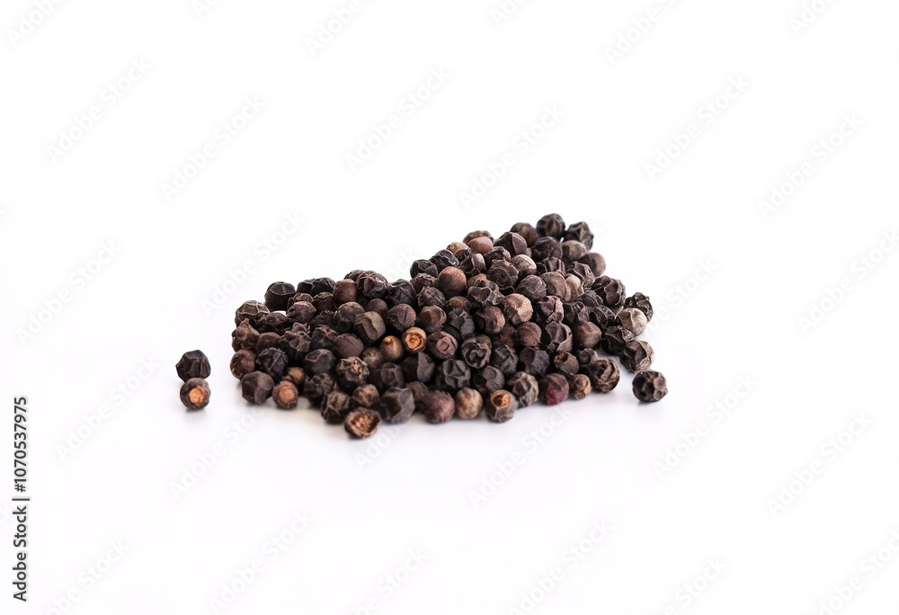 Pile of black peppercorns on a white background Pile of black peppercorns on a white background