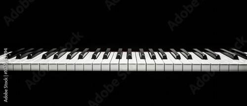 Close-up view of piano keys arranged in a straight line against a black background