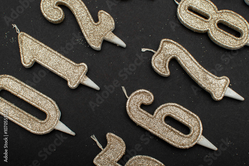 Birthday numeral candles on black background