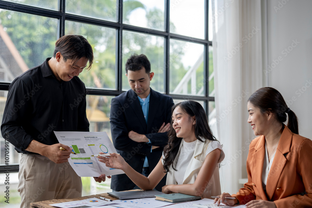 Asian business team analyzing financial charts and business growth in modern office meeting room Asian business team analyzing financial charts and business growth in modern office meeting room