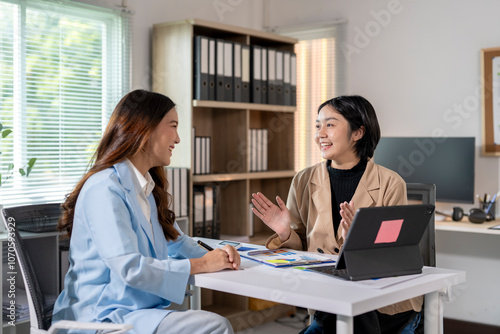 Two asian businesswomen having a meeting in the office