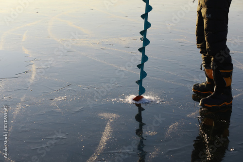 Ice ax - ice screws on winter fishing on the ice caves. Ice is very clean and beautiful. The Lake Baikal. photo