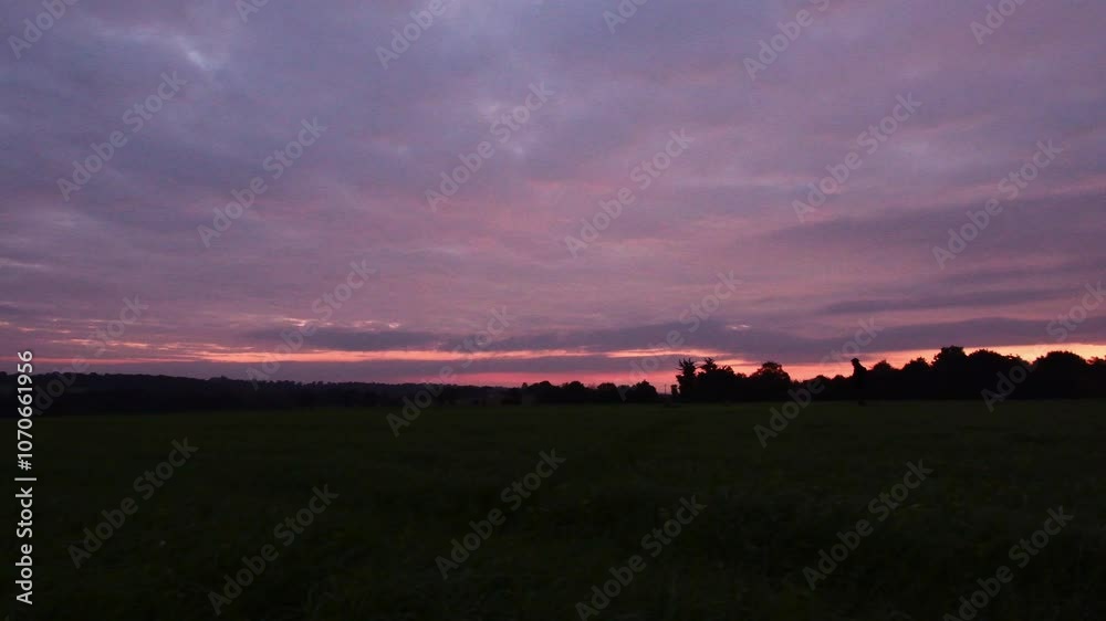 A person walking at sunrise in the countryside A person walking at sunrise in the countryside