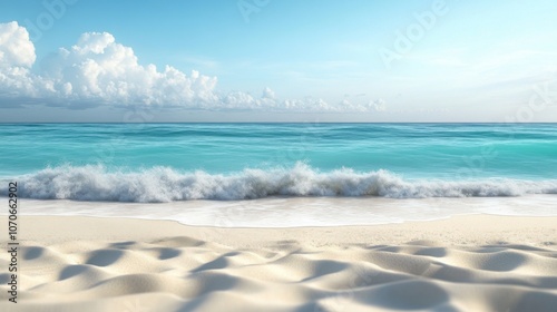 Tranquil beach scene with soft waves and a clear blue sky, creating a serene atmosphere near the shore.