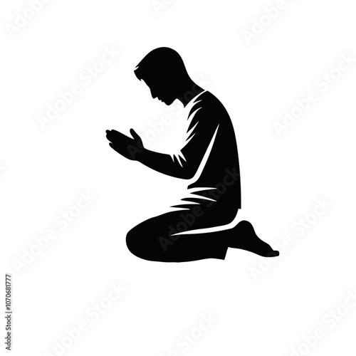 Silhouette of a person praying in a kneeling position