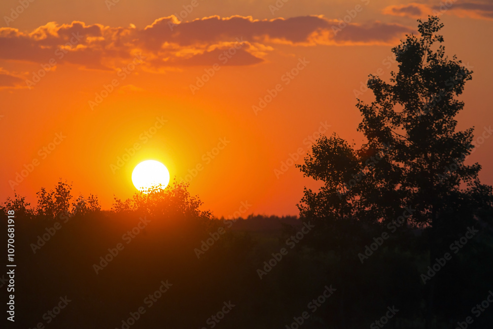 Bright sunset over the fields. Agricultural landscape in eastern Lithuania.