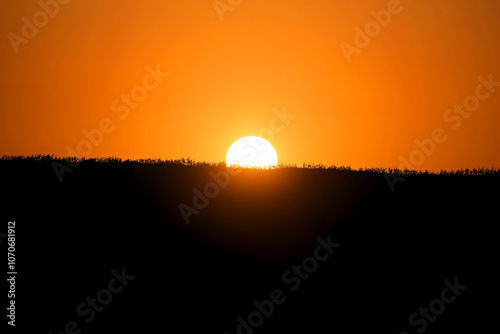 Bright sunset over the fields. Agricultural landscape in eastern Lithuania.