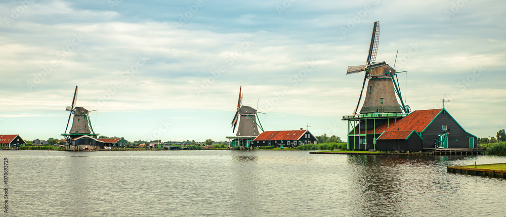 Traditional village with old houses and windmills in Netherlands