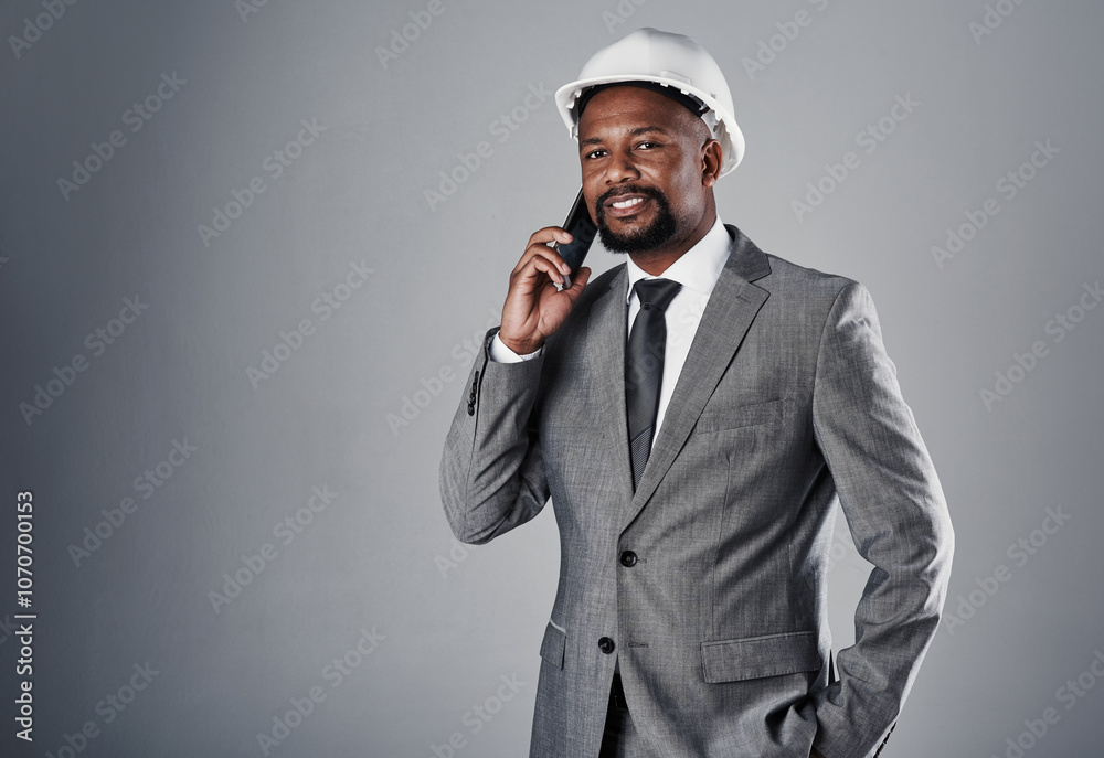 Phone call, architecture and portrait of man in studio for construction, engineering and building project. Helmet, gray background and person on smartphone for talking, conversation and communication Phone call, architecture and portrait of man in studio for construction, engineering and building project. Helmet, gray background and person on smartphone for talking, conversation and communication