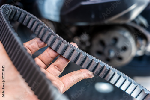 Obraz na płótnie Motorcycle mechanic check the condition of motorcycle transmission belt or Drive belt ,working at garage, maintenance and repair motorcycle concept w salonie